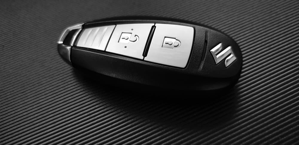 A car key fob resting on a dark surface