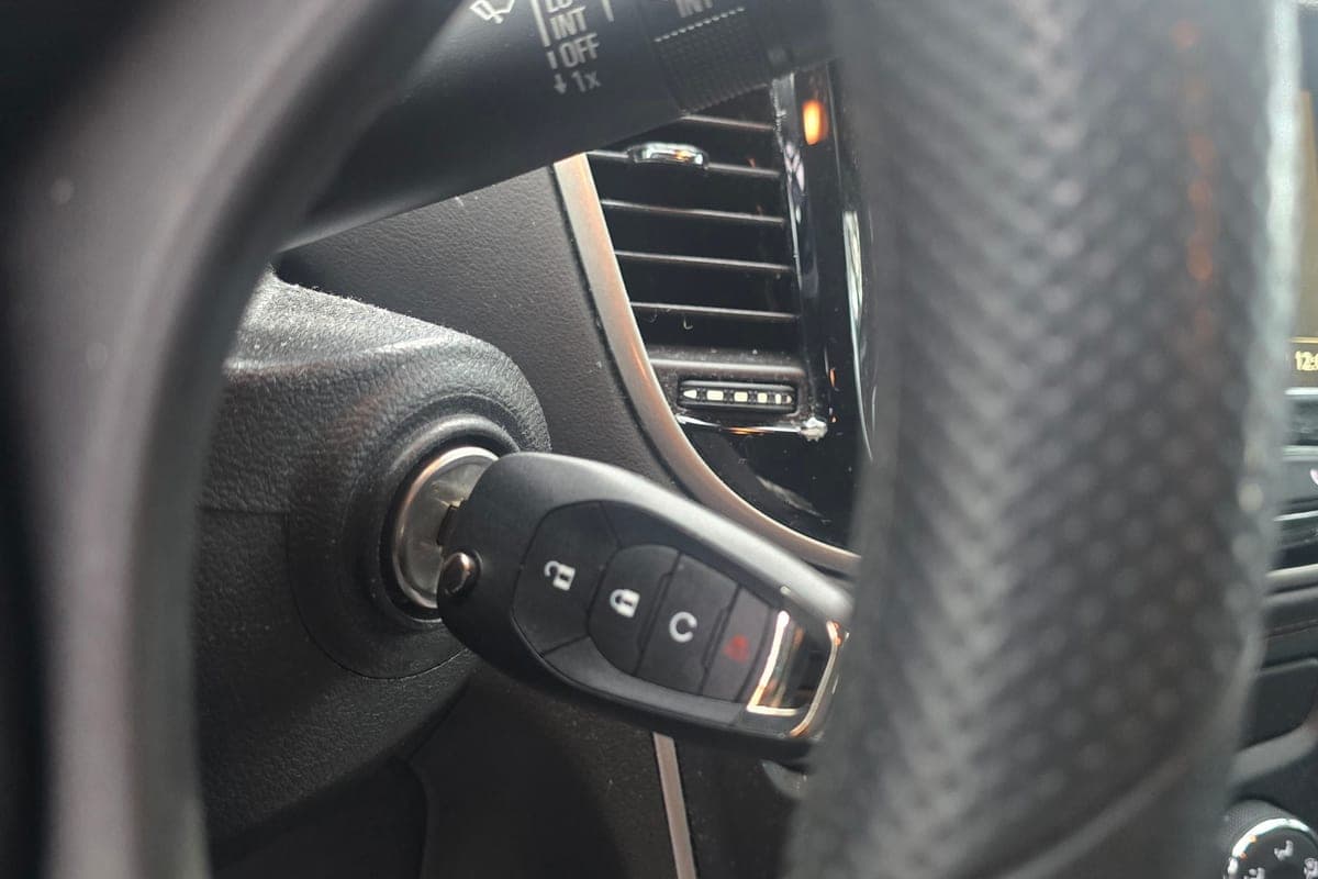 A car key fob turned in the ignition switch